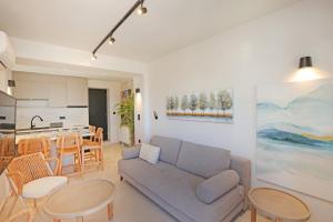 a living room with a couch and a kitchen at VF34 Patio House in Ermoupoli