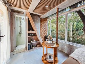 a bathroom with a shower and a table in a room at Teresito Dragon Fruit Farm in Bantayan Island