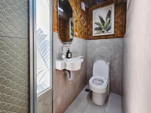 a small bathroom with a toilet and a sink at Teresito Dragon Fruit Farm in Bantayan Island