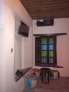 a room with a window and a table and stool at Center Medina in Fez