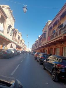 a street with cars parked on the side of the road at Center Medina in Fez +13 photos
