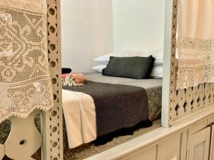 a bedroom with a bed and a mirror at Traditional Villa Sofia in Koskinou