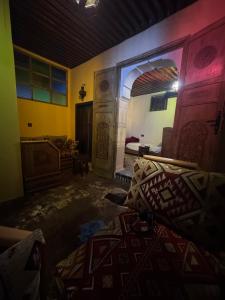 a room with a bedroom with a bed and a mirror at Esc 9 in Fez +8 photos