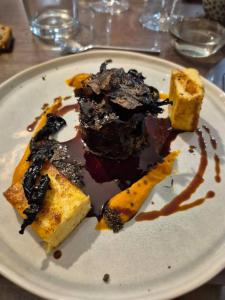 a plate with a chocolate dessert on a table at Une escale gourmande- Suite avec terrasse & dîner maison possible in Eyzerac +27 photos