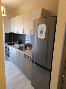 a kitchen with a stainless steel refrigerator and a sink at Villa Emily in Nikiti