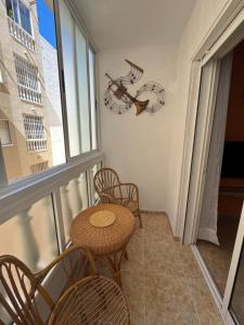 a balcony with a table and chairs and a window at Apartment Vicente casa 119 in Torrevieja