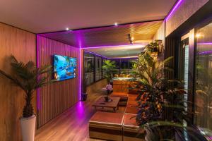 a living room with purple lights on the wall at Complex Rediu 54 - Penthouse Nr. 41 in Iaşi