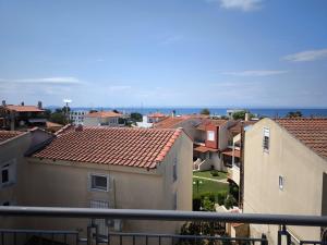 a view of a city with houses and the ocean at Villa Emily in Nikiti