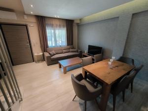 a living room with a table and a couch at Villa Emily in Nikiti