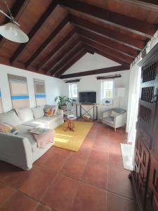 a living room with a couch and a table at Casa MaLuMi - Historisches Stadthaus in Haría in Haría +29 photos