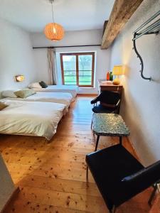 a room with four beds and a desk and a chair at Entre Loue et Lison in Amondans