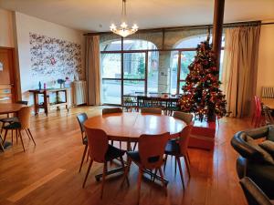 a living room with a table and a christmas tree at Entre Loue et Lison in Amondans
