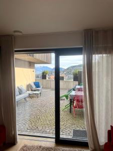 a sliding glass door with a view of a patio at Casa con vista Sciliar centro paese PINK con parcheggio privato in Völs am Schlern