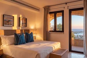 a bedroom with a bed with a view of the ocean at La Tiara di Cervo in Porto Cervo +48 photos