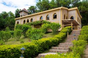 a building with a staircase in front of it at Le Chateau du Lac de Mantasoa in Mantasoa