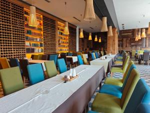 a row of tables and chairs in a restaurant at Mecavnik Resort in Mokra Gora