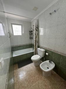 a bathroom with a toilet and a tub and a sink at Apartment Vicente casa 119 in Torrevieja +23 photos