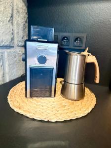a tea kettle sitting on a table next to a box at Za kovárnou in Zděchov +15 photos