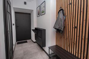 a hallway with a shoe hanging on a wall at Apartament Podchorążych Dęblin in Dęblin