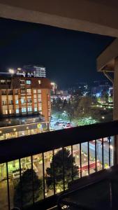 a view of a city at night from a balcony at HTH Apartments in Center of Gjakova - 4th Floor in Gjakove +7 photos