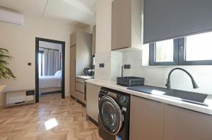 a kitchen with a washing machine and a sink at VF34 Seaview House in Ermoupoli