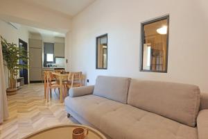 a living room with a couch and a table at VF34 Seaview House in Ermoupoli