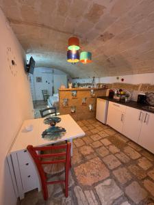 a kitchen with a table and a counter top at Il Cuore di San Cipriano in Mesagne