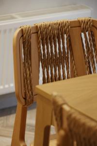 a wooden chair next to a wooden table with a ropeaired at VF34 Seaview House in Ermoupoli