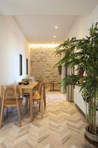 a dining room with a table and a plant at VF34 Seaview House in Ermoupoli