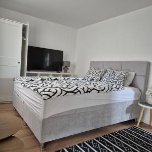 a bedroom with a large bed with a television at Roko Apartments in Biograd na Moru