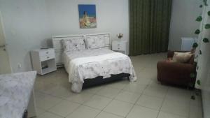 a bedroom with a bed and a couch and a chair at Pousada do Bosque in Rio Branco +48 photos