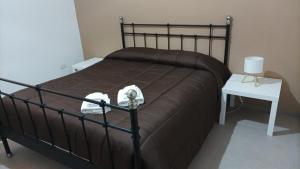 a bedroom with a bed and a table with a phone on it at Penelope in Agrigento