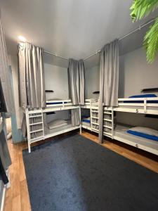 a room with three bunk beds and a rug at Guest World in Porto