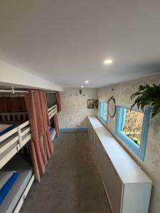 a room with two bunk beds and a window at Guest World in Porto