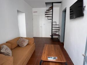 a living room with a couch and a table at Apartamentos Plaza Minas in Minas