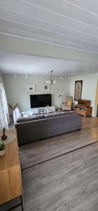 a living room with a large couch in a room at Arctic House Kemi 7 GUEST, outdoor tentsauna Experience in Kemi