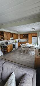 a large kitchen with wooden cabinets and a table at Arctic House Kemi 7 GUEST, outdoor tentsauna Experience in Kemi
