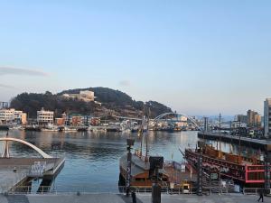 a view of a river with boats in a city at 아름다운호텔 in T'ongyŏng