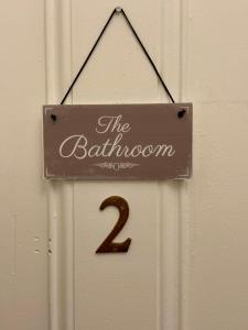 a door with a sign that reads the bathroom two at Piccolo in Glasgow
