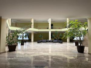 a lobby with potted plants in a building at Arena Hotel Tovuz in Tovuz