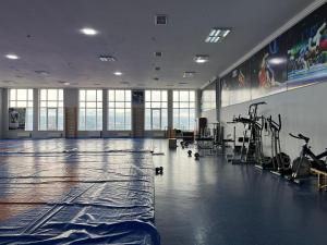 a gym with an empty floor with exercise equipment at Arena Hotel Tovuz in Tovuz