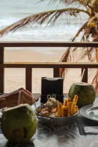 a table with a plate of food on the beach at Vila Refúgio in Aracati