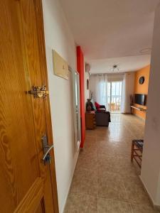 a room with a door and a living room at Apartment Vicente casa 119 in Torrevieja