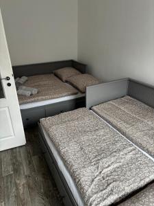 three mattresses in a room with three beds at Apartmán u Hradu 2 in Cheb
