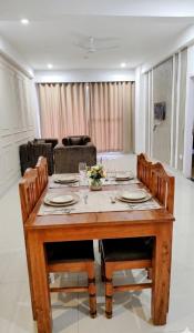a dining room with a table and chairs at Orchards Suites Lansdowne in Lansdowne