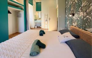 a large bed in a room with two pillows on it at La Vieille Forge in Sarrazac