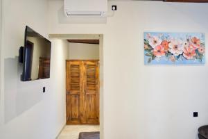 a hallway with a door and a painting on the wall at Inaya Private Pool Villa in Ambat