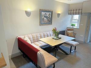 a living room with a couch and a table at Jasmine Cottage in Grassington