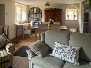 a living room with a couch and a dining room at The Mains in Keldhead
