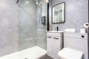 a bathroom with a shower and a toilet and a sink at No1 Coppergate - Donnini Apartments in Prestwick
